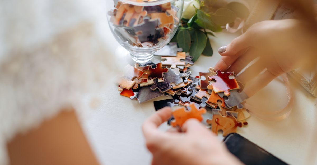 Une femme arrangeant des pièces de puzzle, symbolisant la stratégie d'investissement.
